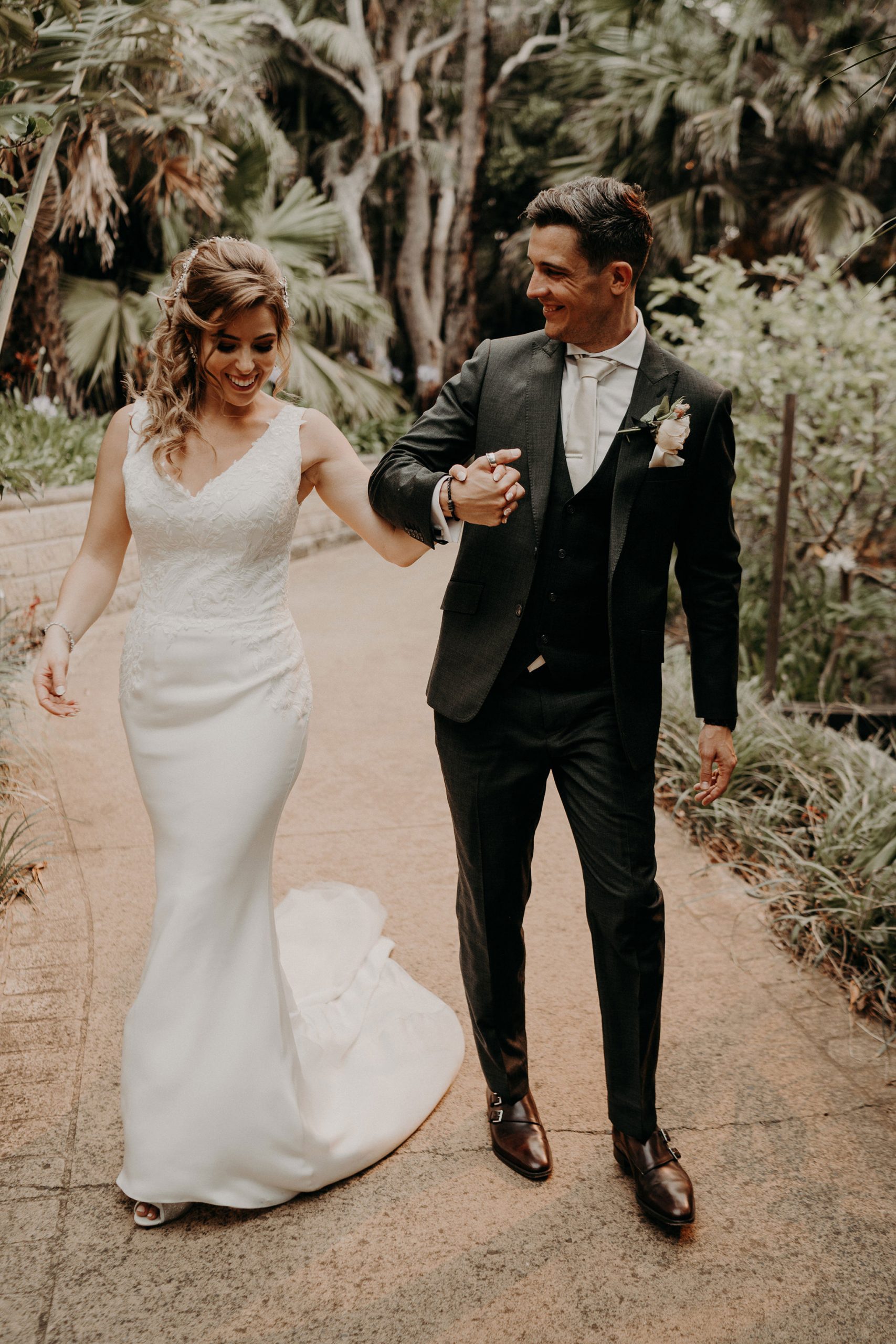 sydney boho elegant wedding. bride and groom walking and laughing